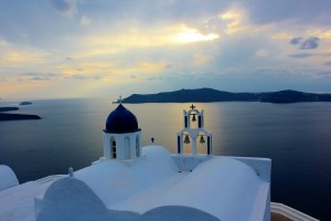 Sunset view from an ocean side church on Santorini. The Greek island of Santorini is famous for its blue domed churches, Santorini, Greece, 