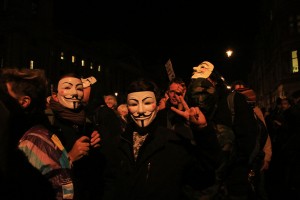 Masked protesters in front of Parliament on Guy Fawkes Day, London, England